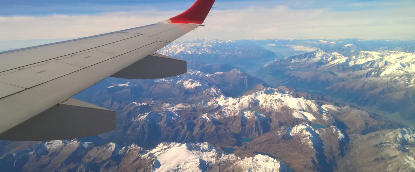aircraft wing over mountains